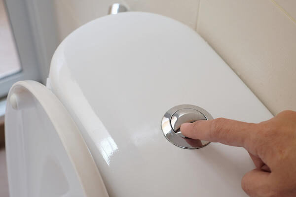 finger-pushing-button-flushing-toilet-2